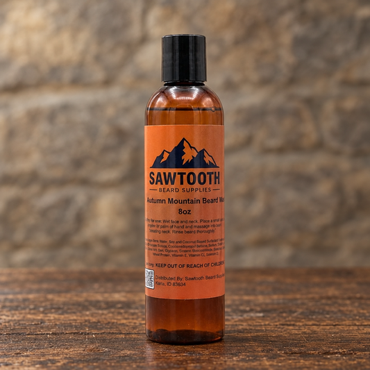 Autumn Mountain Beard Wash in its orange-labeled bottle on rustic wood against a stone backdrop