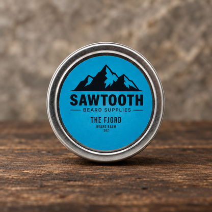 Fjord Beard Balm in its cyan-labeled silver tin on rustic wood against a stone backdrop
